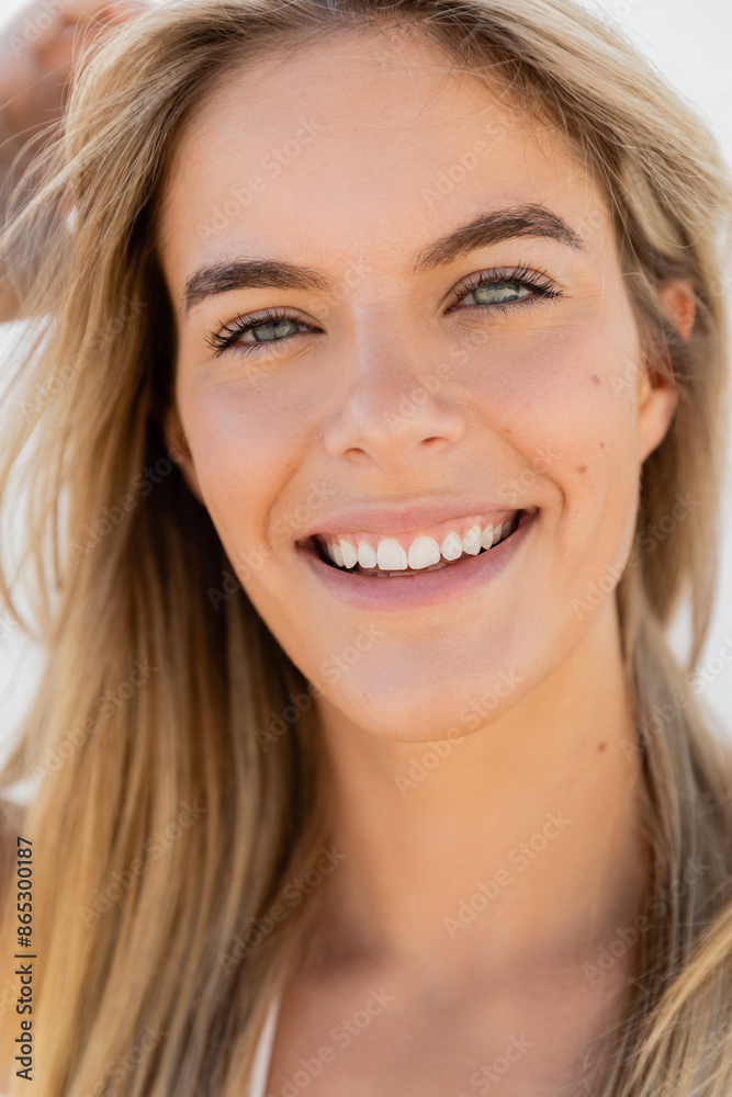 A young and beautiful blonde woman with long hair smiling at the camera on Miami Beach. A young and beautiful blonde woman with long hair smiling at the camera on Miami Beach.