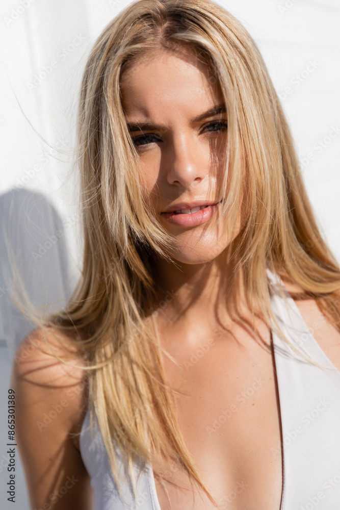 A young, beautiful blonde woman gracefully poses on Miami Beach, her long hair flowing in the breeze. A young, beautiful blonde woman gracefully poses on Miami Beach, her long hair flowing in the breeze.