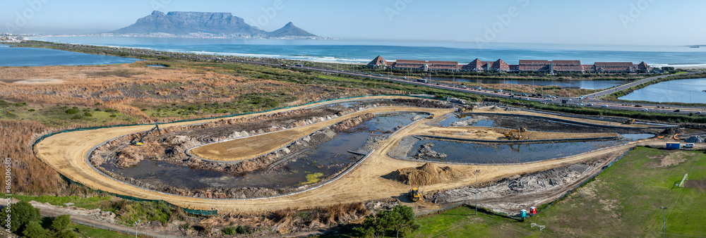 Fototapeta premium Wetlands construction of sedimentation ponds and reed beds to clear storm runoff water from pollutants and organic matter before being released into natural lake in Cape Town, South Africa.