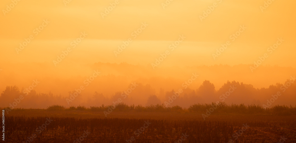 Obraz premium A beautiful minimalist landscape with colorful sunrise skies. Bright summer scenery of rural Latvia, Northern Europe.