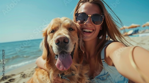 Happy woman taking selfie with her dog during summer day on beach. © Nijat
