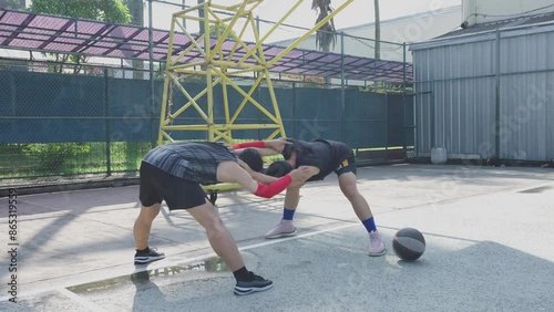 Two Young Asian Men Bowing Their Body Doing Warming Up Before Playing Basketball On Court