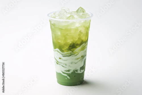 a cup of green liquid with ice