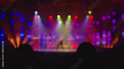 Blurry Image Of Dancers Dancing On The Stage Under Colorful Spotlights