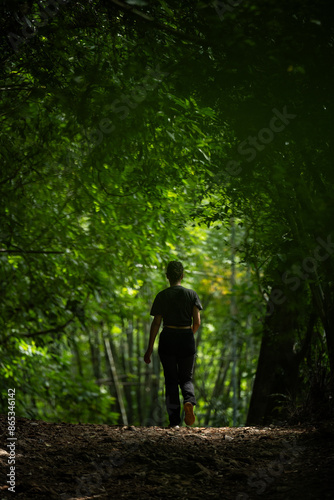 Obraz na płótnie Stunning view of a girl walking in a beautiful rainforest. Khao Sok National Park, Thailand. w salonie
