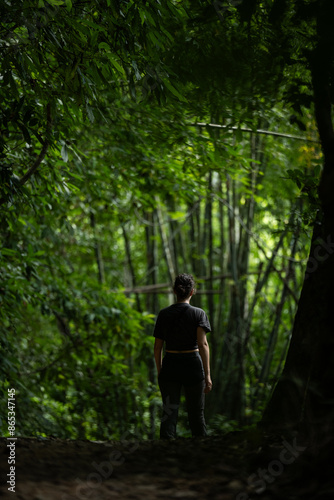 Stunning view of a girl walking in a beautiful rainforest. Khao Sok National Park, Thailand.