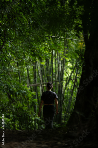 Obraz na płótnie Stunning view of a girl walking in a beautiful rainforest. Khao Sok National Park, Thailand. w salonie