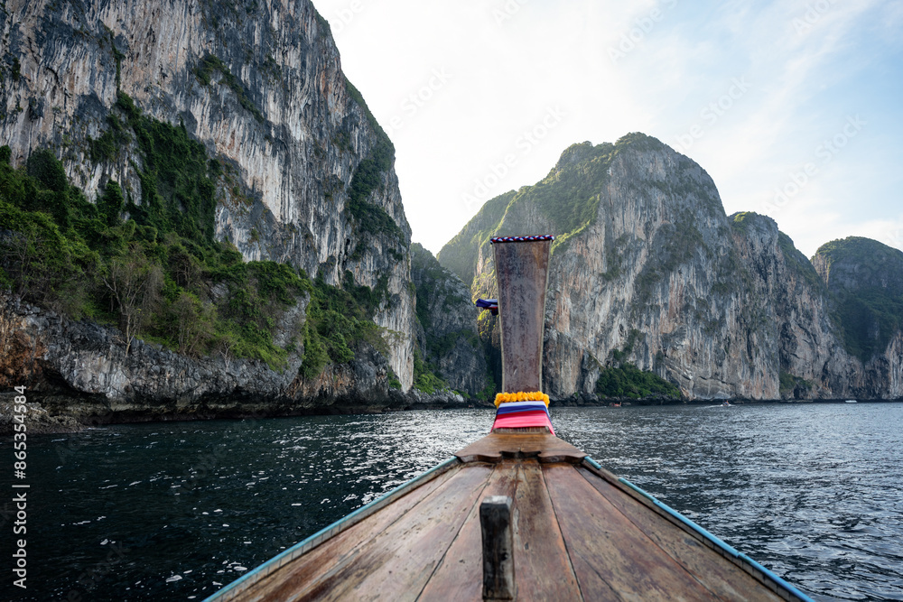 (Selective focus) Stunning view of some limestone mountains in the background and a beautiful long tail boat in the foreground. Phi Phi Islands, Thailand.