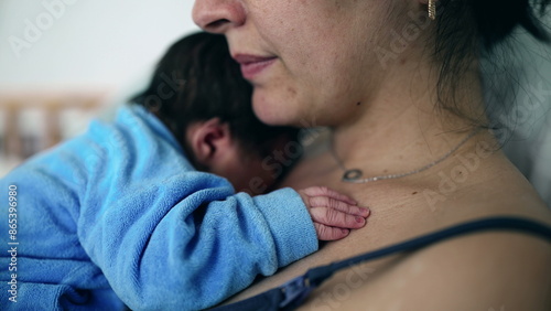 Close-up of a newborn baby resting on mother's chest, highlighting tender moments of early bonding, healthcare setting, postnatal care, emotional connection, new family, nurturing love photo