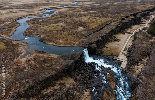 Obraz na plátne Aerial panorama of Oxarafoss waterfalls in Thingvellir National Park, Iceland, featuring the scenic Oxara River and the unique landscape created by the tectonic plates of America and Eurasia