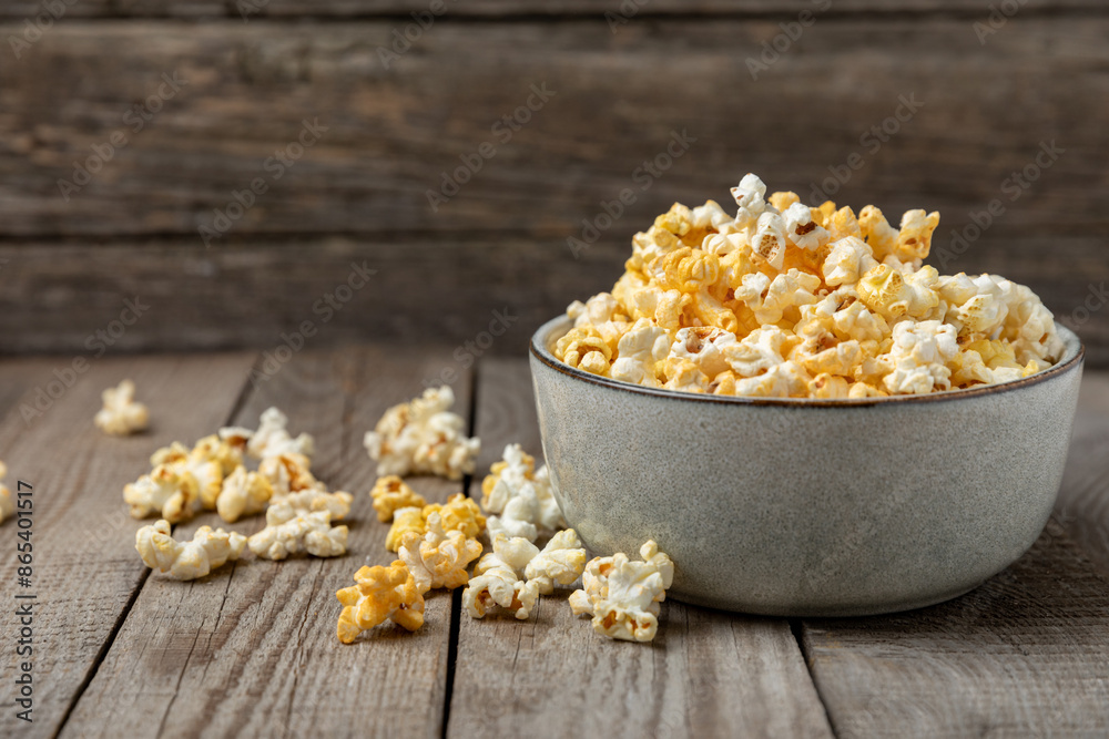 Tasty popcorn on wooden background. Cinema and entertainment concept. Movie night with popcorn.Cheese and caramel popcorn. Delicious appetizer, snack. Place for text. Copy space.Banner Tasty popcorn on wooden background. Cinema and entertainment concept. Movie night with popcorn.Cheese and caramel popcorn. Delicious appetizer, snack. Place for text. Copy space.Banner