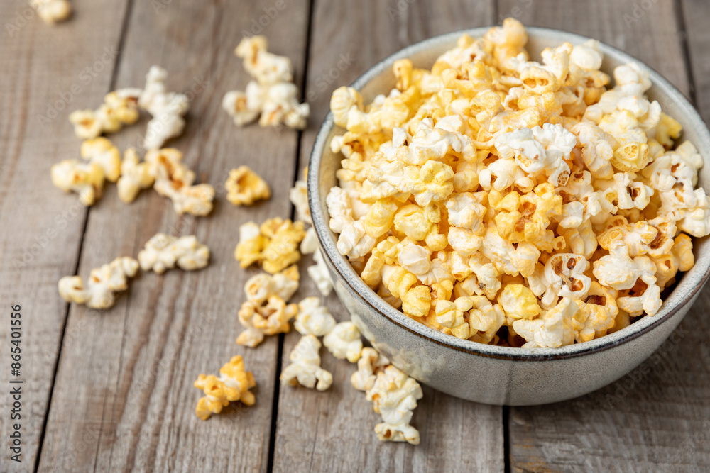 Tasty popcorn on wooden background. Cinema and entertainment concept. Movie night with popcorn.Cheese and caramel popcorn. Delicious appetizer, snack. Place for text. Copy space.Banner Tasty popcorn on wooden background. Cinema and entertainment concept. Movie night with popcorn.Cheese and caramel popcorn. Delicious appetizer, snack. Place for text. Copy space.Banner