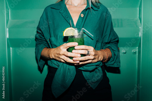 Canvas Print An unrecognizable woman holds a cool cocktail in her hands.
