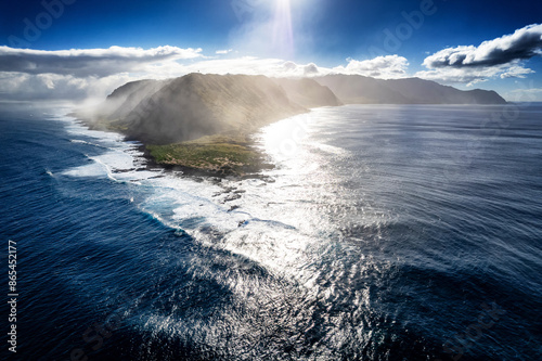 Wide aerial view of Kaena Point, the northwesternmost point of Oahu, Hawaii with the sun right above the western shore photo