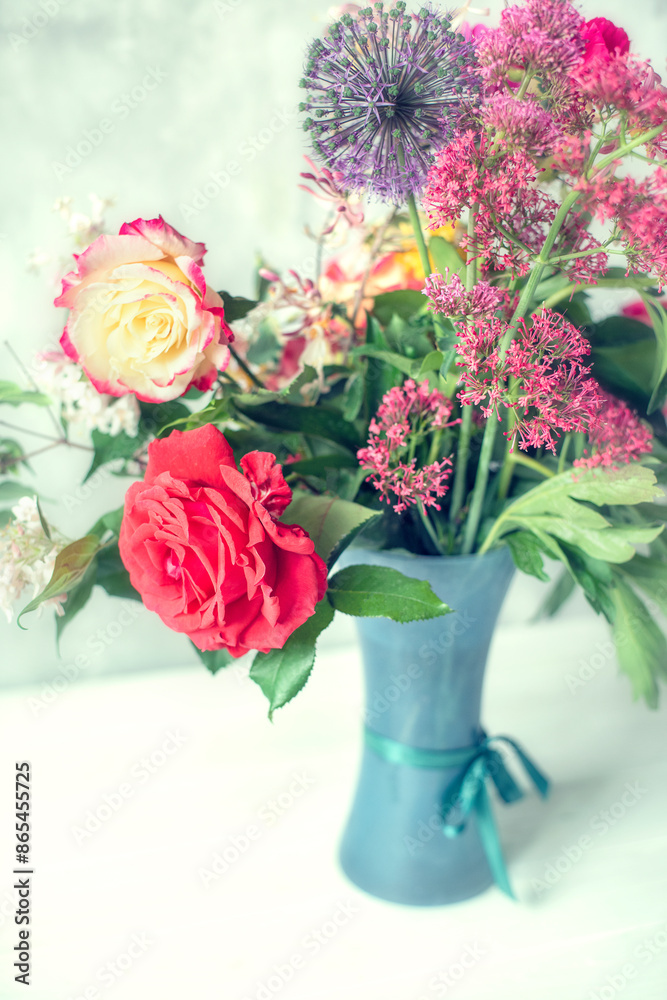 Bouquet of different flowers collected in the garden on a gray background. Vintage style, photo for wall and interior decor in a simple rustic style Bouquet of different flowers collected in the garden on a gray background. Vintage style, photo for wall and interior decor in a simple rustic style