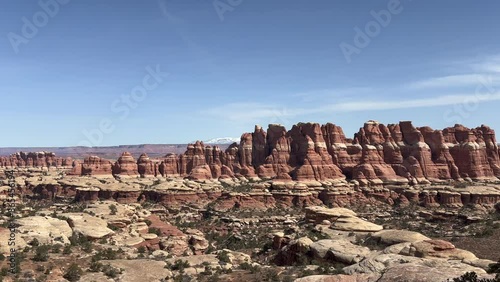 A stunning view of the rock formations in Canyonlands National Park, Utah. The Needles district features a rugged landscape of canyons and sandstone spires. The La Sal Mountains in background - USA