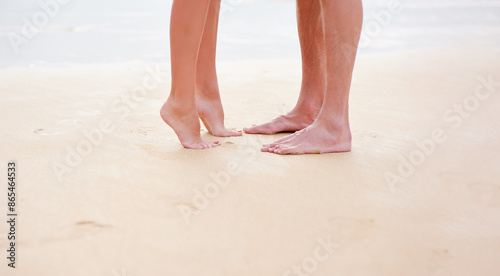 Close up male and female feet on the sand beach photo