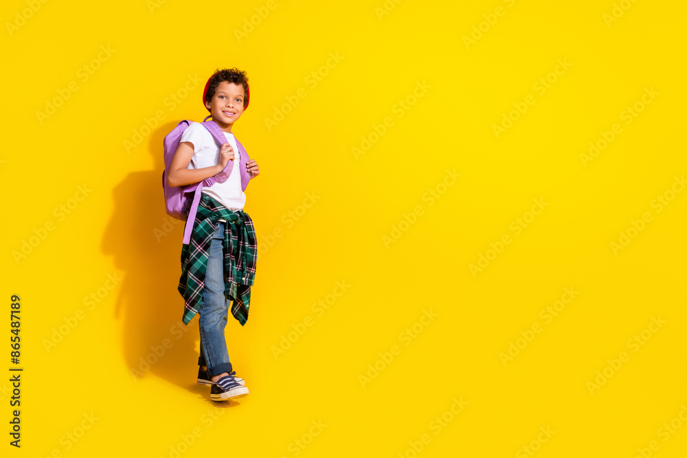Full size photo of small charming boy backpack walk school wear trendy white outfit isolated on yellow color background Full size photo of small charming boy backpack walk school wear trendy white outfit isolated on yellow color background
