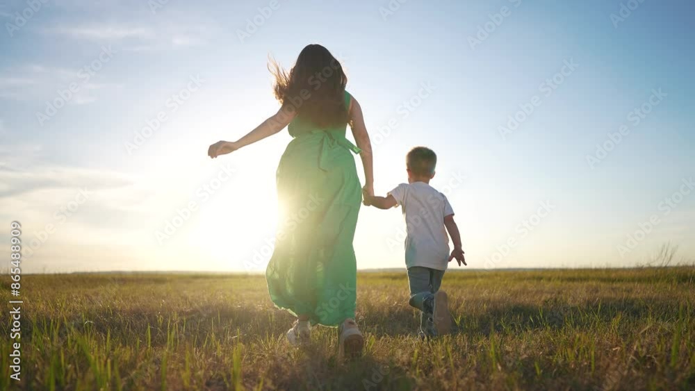 Mother and son running in nature. Happy family kid dream concept. Mother and her family are running together holding hands. Mother and son running in nature with lifestyle their family. Mother and son running in nature. Happy family kid dream concept. Mother and her family are running together holding hands. Mother and son running in nature with lifestyle their family.