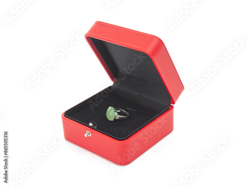 Red gift case with silver ring with gemstone on white background