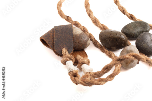 Antique Sling Shot and Stones on a White Background from the Story of David and Goliath in the Bible