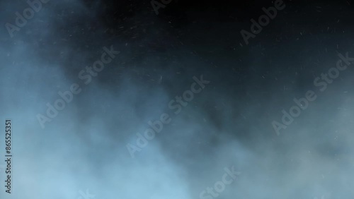 Blue Smoke and Ash Rolling 4K Loop features blue hued smoke and ash or snow rolling from left to right against a black background in a loop.
