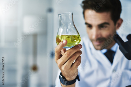 Hand, beaker and scientist with liquid in laboratory for clinical analysis, experiment and scientific study. Male doctor, fluid and sample for chemical reaction, medical research and innovation.