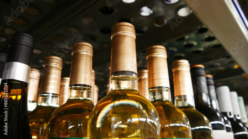 Many golden bottles of wine on a retail display