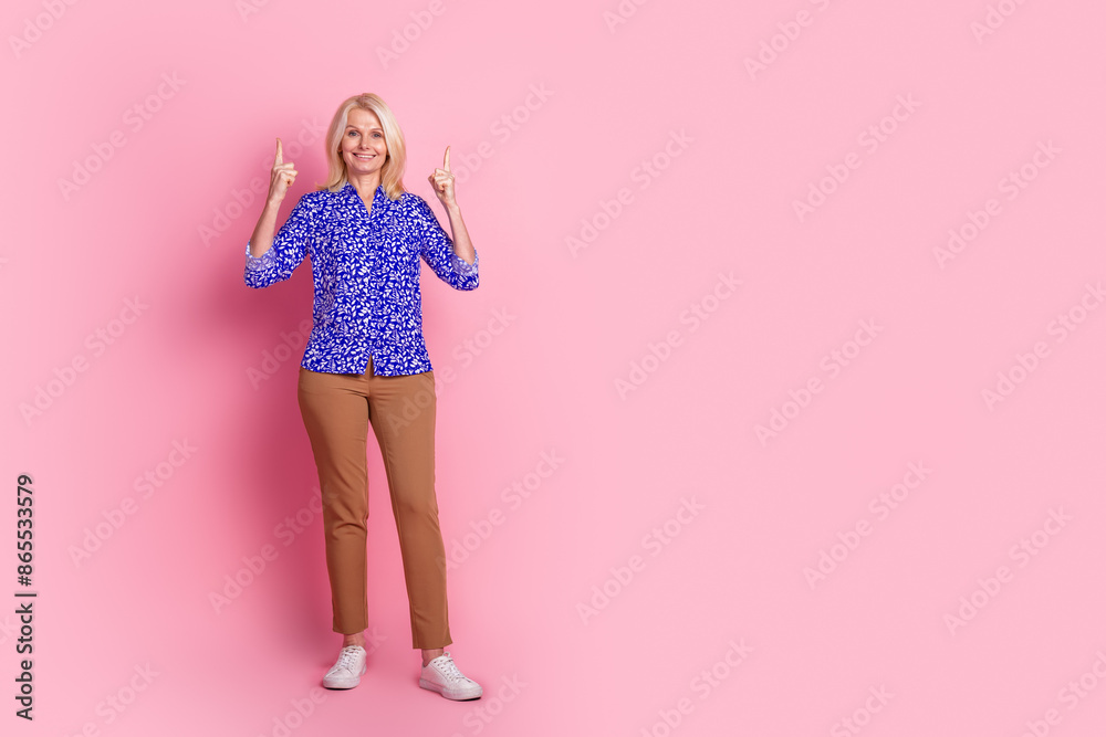 Full body portrait of nice elegant lady direct fingers up empty space wear shirt isolated on pink color background Full body portrait of nice elegant lady direct fingers up empty space wear shirt isolated on pink color background