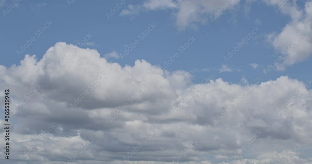 Panning background of big puffy clouds against a bright blue sky. Panning background of big puffy clouds against a bright blue sky.