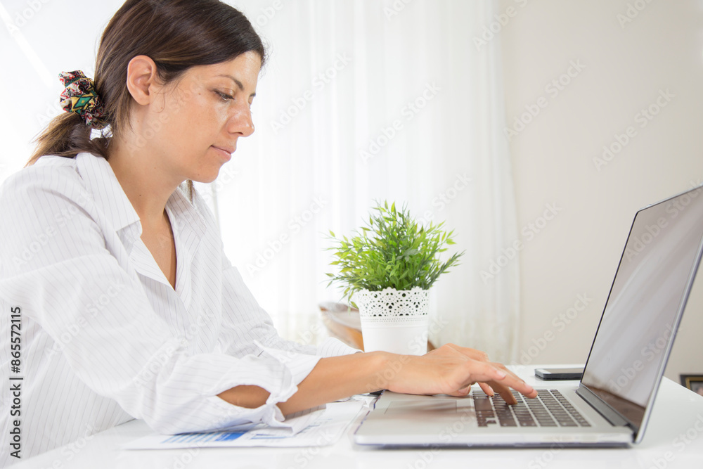 Woman using laptop when working from home office. remote working concept Woman using laptop when working from home office. remote working concept