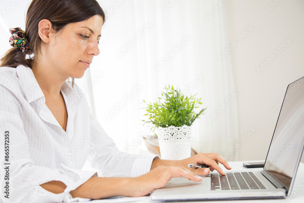 Woman using laptop when working from home office. remote working concept Woman using laptop when working from home office. remote working concept