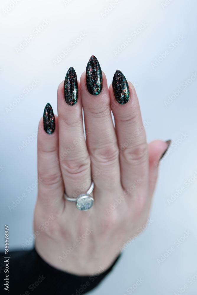 Female hands with long nails and black manicure Female hands with long nails and black manicure