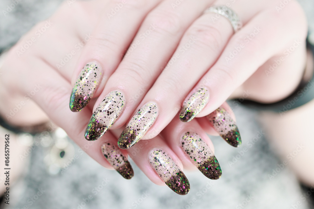 Woman's hands with long nails and white and black thermo