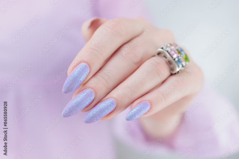 Woman hands with long nails manicure and light blue lilac pink nail polish Woman hands with long nails manicure and light blue lilac pink nail polish