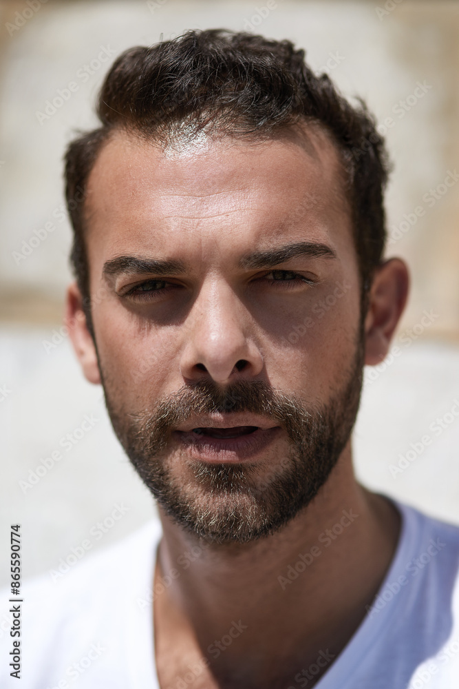 Man, portrait and face with beard outdoor in tshirt as confidence, cool and trendy person in summer. Male model, calm and relax by wall with facial hair for fashion, sexy and aesthetic with pride Man, portrait and face with beard outdoor in tshirt as confidence, cool and trendy person in summer. Male model, calm and relax by wall with facial hair for fashion, sexy and aesthetic with pride