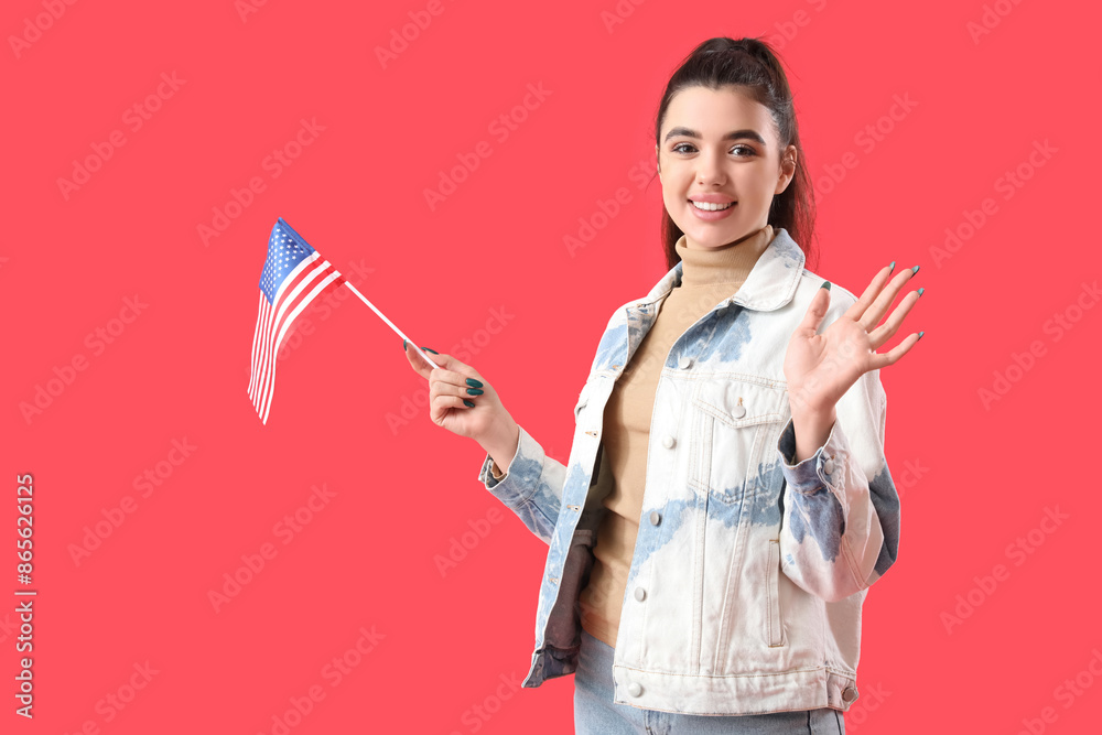Young woman with USA flag waving hand on red background Young woman with USA flag waving hand on red background