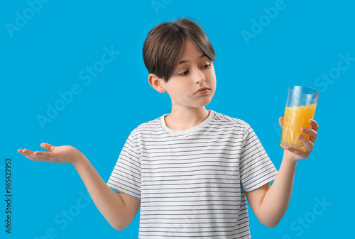 Little boy with glass of or...