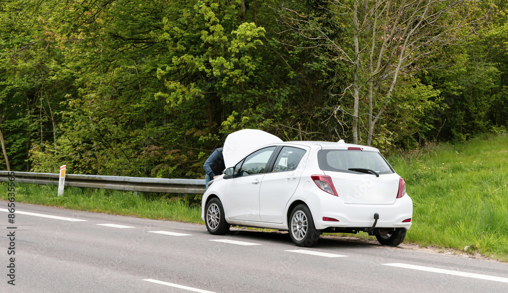 Fototapeta premium Broken car with open hood on the side of the highway. High quality photo