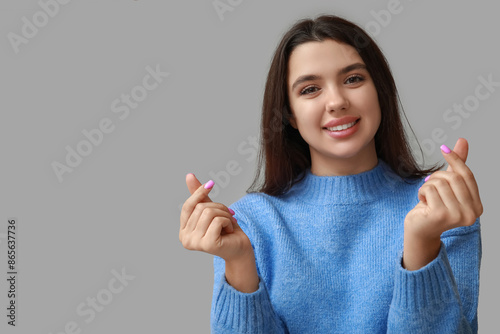 Happy young girl showing he...