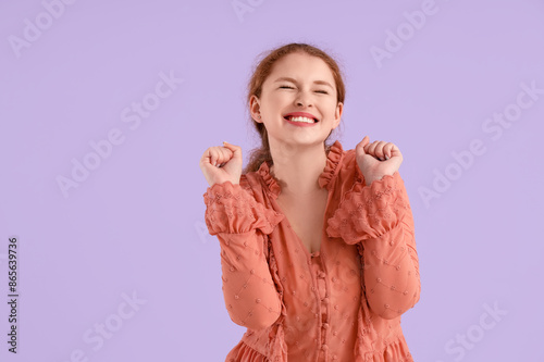 Smiling young redhead woman...