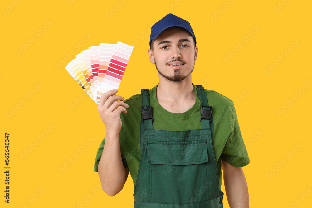 Young painter with color palettes on yellow background Young painter with color palettes on yellow background
