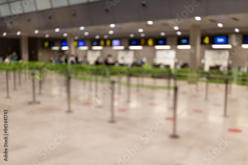 Airport waiting for passengers, Crowd Control barriers. Barrier tape on an airport. Blur abstract background. Blurred and defocused image of Airport Terminal.