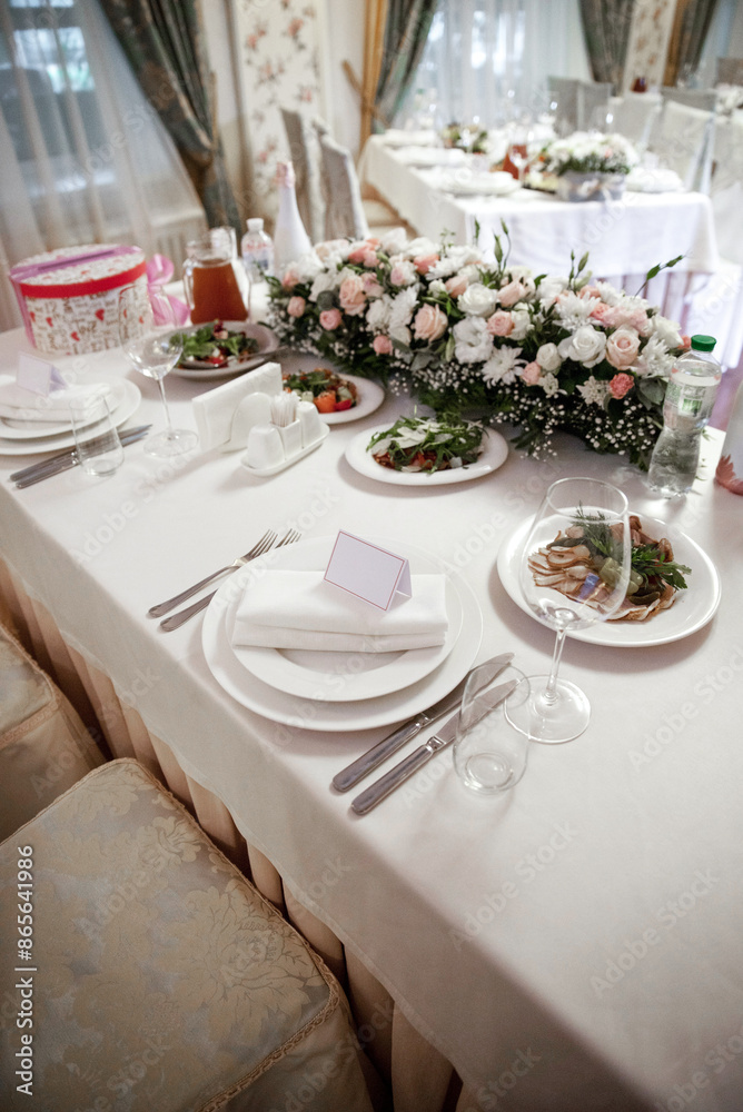 Empty glasses and dishes on a wedding table with flowers