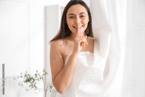 Young woman showing silence...
