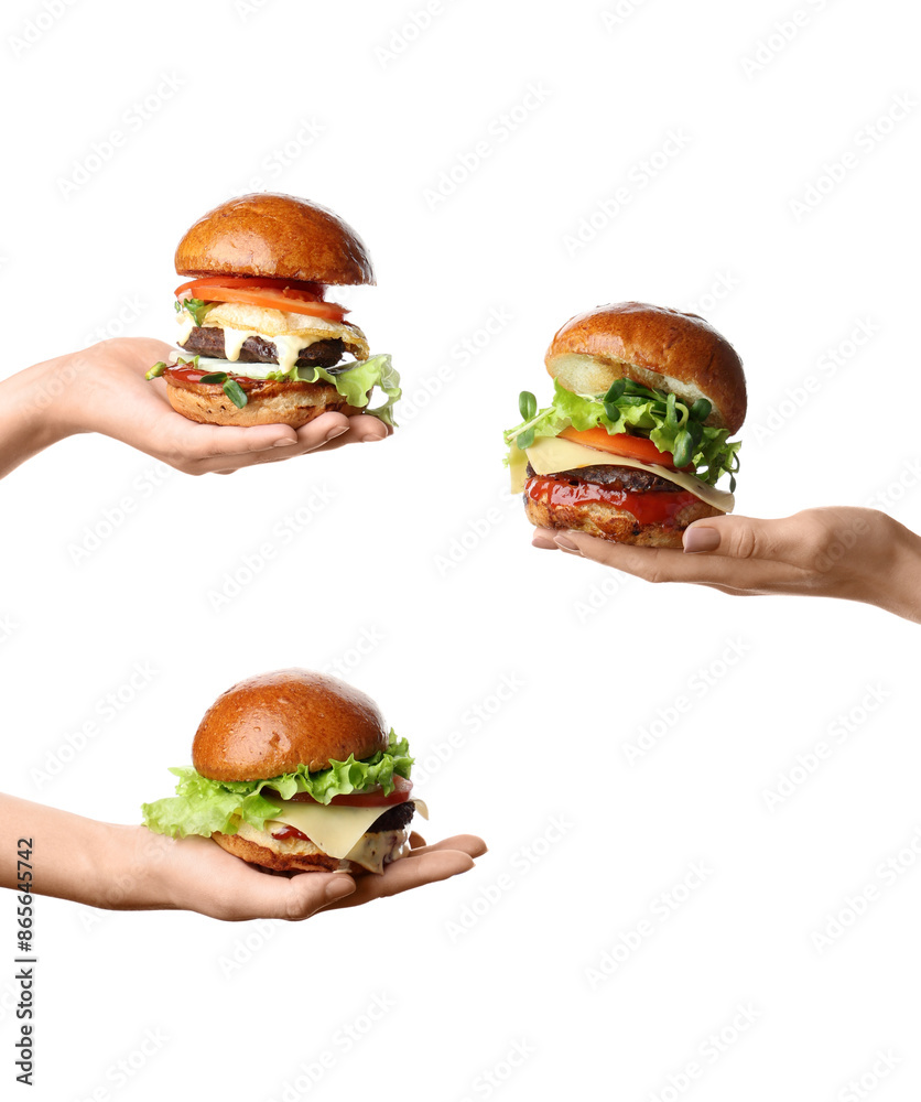 Female hands holding tasty burgers on white background Female hands holding tasty burgers on white background