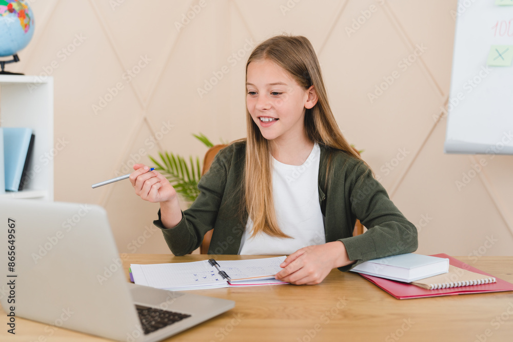 Remote education on lockdown, e-learning concept. Young caucasian student schoolgirl pupil having video call lesson online on laptop from home. Remote education on lockdown, e-learning concept. Young caucasian student schoolgirl pupil having video call lesson online on laptop from home.