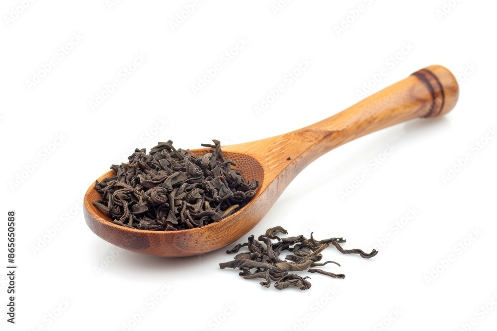 A wooden spoon filled with black tea leaves A wooden spoon filled with black tea leaves