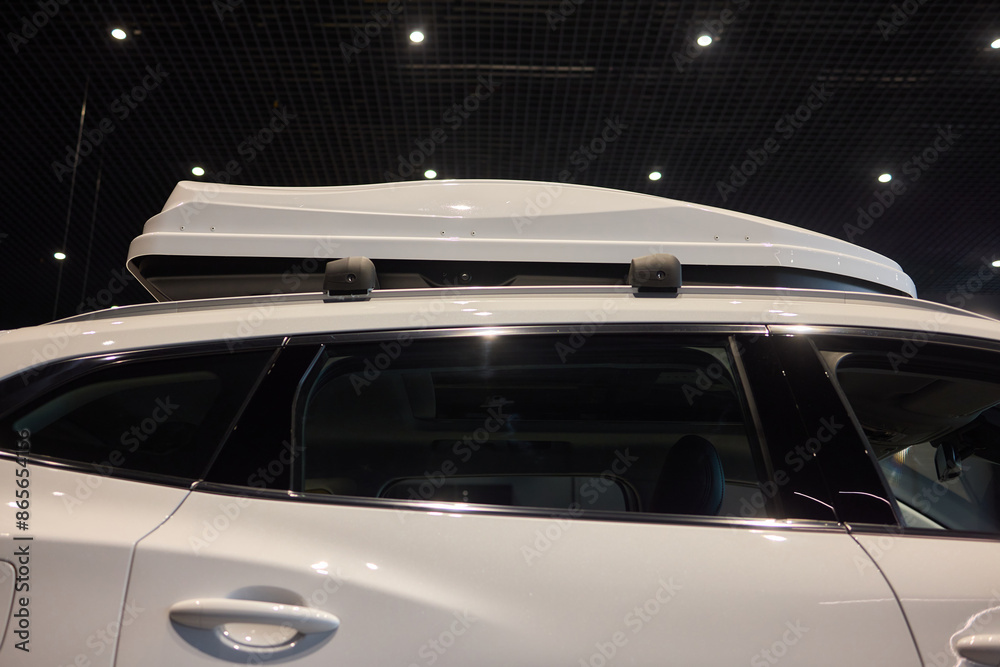 Fototapeta premium White vehicle with roof box, hood, grille, bumper and automotive lighting