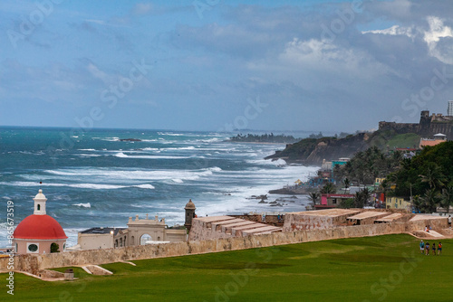 San Juan coast and red chapel structure with rough surf photo